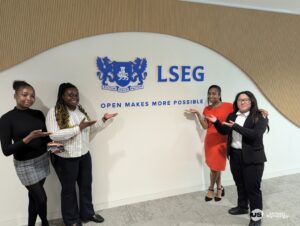 Three young people stand near the London Stock Exchange Group logo while attending work experience.