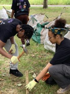 A young man and woman are planting in a South London Park as part of the DreamBig@WTW programme