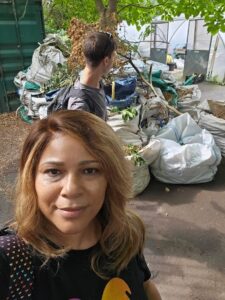 WTW director Cheree Psalms looks into the camera as her colleague surveys the clearing up work of the DreamBig@WTW programme