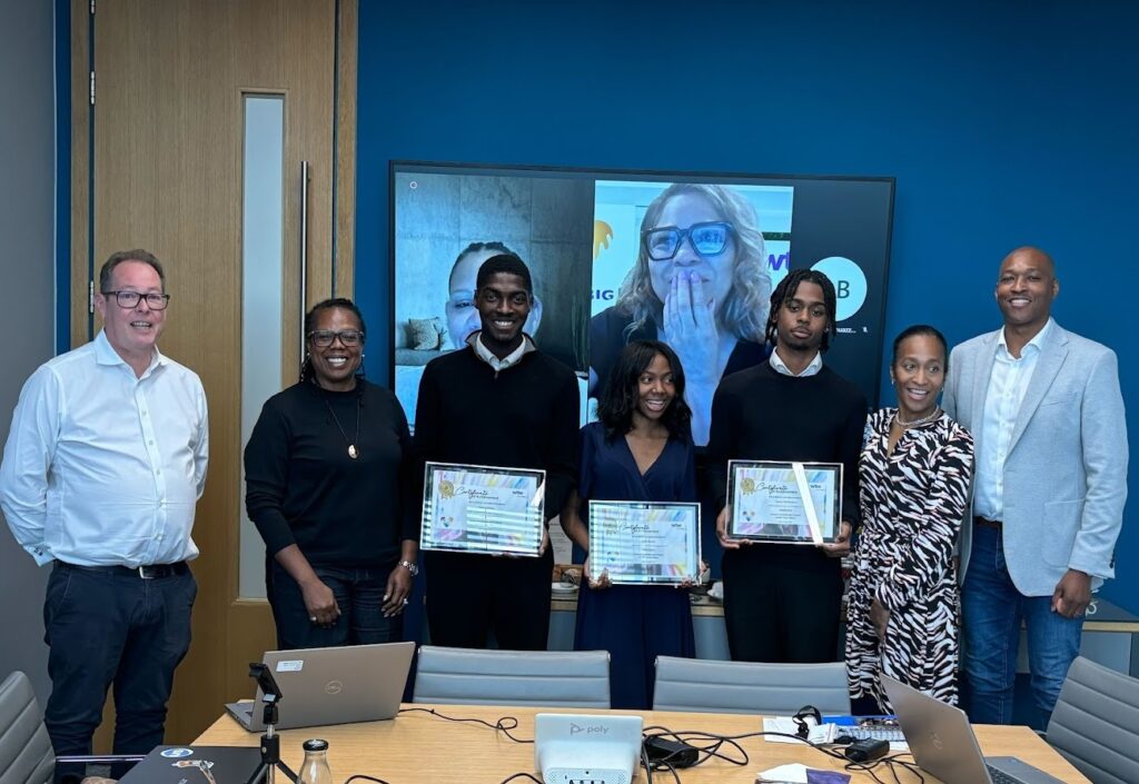 A group of young people on the DreamBig@WTW programme receive their awards. with executives from WTW and the CEO of Urban Synergy