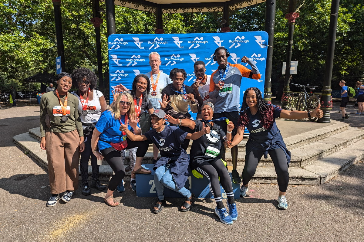 Group of Urban Synergy charity fundraisers smile and pose for the camera after completing a fun run.